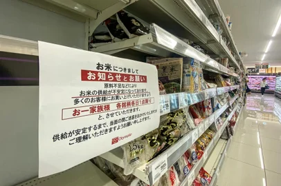 Empty shelves of rice are pictured in a supermarket with a notice written: "Due to shortage of resource materials, supply of rice has been unstable. In order for many customers to be able to buy, we ask you to purchase one (bag of rice) a day a family. We beg you for your understanding for causing troubles for a while until supply stabilises." at the neighbourhood of Morishita in Koto district of Tokyo on August 27, 2024. Shortages have been caused by a number of factors including shoppers stockpiling following a warning of a 'megaquake' earlier this month as well as increased consumption by foreign tourists. The government says supplies will soon improve. (Photo by Philip FONG / AFP)<!-- NICAID(15851319) -->