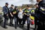Swedish climate activist Greta Thunberg (C) is arrested during a climate march against fossil subsidies near the highway A12 in the Hague, on April 6, 2024. Dozens of police officers, some on horseback, blocked protesters from reaching the A12 arterial highway into the Dutch seaside city, the scene of previous actions organised by the Extinction Rebellion (XR) group (Photo by Ramon van Flymen / ANP / AFP) / Netherlands OUT<!-- NICAID(15727525) -->