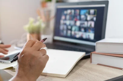 Teacher people lecture note by webinar application for distant education. Internet wireless for distant learning by communication software and online browsing while event zoom or messenger appFonte: 519234025<!-- NICAID(15702539) -->