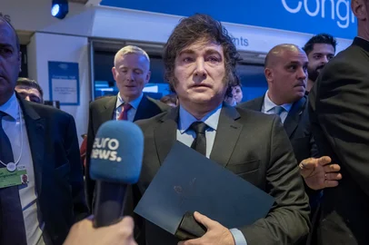 Argentinas President Javier Milei (C) addresses media during the World Economic Forum (WEF) annual meeting in Davos on January 23, 2025. Milei said at a Bloomberg event on January 22, 2026 that "The world should celebrate the arrival of President Trump,"before Donald Trump will star on January 23, 2025 in an eagerly-anticipated online appearance at the World Economic Forum in Davos, addressing global elites whose annual gabfest has been consumed by the US president's days-old second term. (Photo by FABRICE COFFRINI / AFP)Editoria: POLLocal: DavosIndexador: FABRICE COFFRINISecao: diplomacyFonte: AFPFotógrafo: STF<!-- NICAID(15960105) -->
