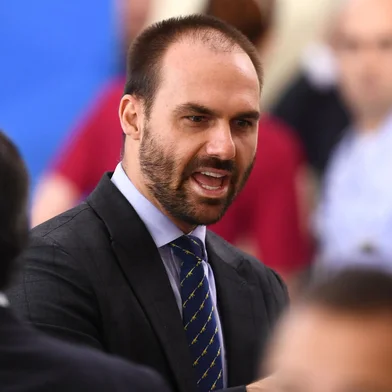 (FILES) In this file photo taken on April 17, 2020, Brazilian Deputy Eduardo Bolsonaro, son of Brazilian President Jair Bolsonaro, gestures during the swearing-in ceremony of Brazil's new Health Minister Nelson Teich (out of frame) at Planalto Palace in Brasilia. - A Brazilian court on January 21, 2021 ordered Congressman Eduardo Bolsonaro to compensate a journalist for moral damages for claiming that he "tried to seduce" a person to obtain damaging information against his father, President Jair Bolsonaro. (Photo by EVARISTO SA / AFP)<!-- NICAID(14701219) -->