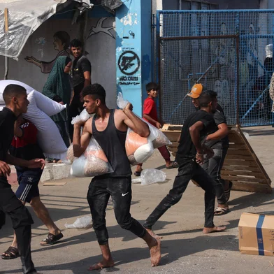 Palestinians storm a UN-run aid supply center, that distributes food to displaced families following Israel's call for more than one million residents in northern Gaza to move south for their safety, in Deir al-Balah on October 28, 2023, amid the ongoing battles between Israel and the Palestinian group Hamas. Thousands of civilians, both Palestinians and Israelis, have died since October 7, 2023, after Palestinian Hamas militants based in the Gaza Strip entered southern Israel in an unprecedented attack triggering a war declared by Israel on Hamas with retaliatory bombings on Gaza. (Photo by MOHAMMED ABED / AFP) / The erroneous mention[s] appearing in the metadata of this photo by MOHAMMED ABED has been modified in AFP systems in the following manner: [Storm] instead of [Collect boxes and and bags from]. Please immediately remove the erroneous mention[s] from all your online services and delete it (them) from your servers. If you have been authorized by AFP to distribute it (them) to third parties, please ensure that the same actions are carried out by them. Failure to promptly comply with these instructions will entail liability on your part for any continued or post notification usage. Therefore we thank you very much for all your attention and prompt action. We are sorry for the inconvenience this notification may cause and remain at your disposal for any further information you may require.<!-- NICAID(15582451) -->