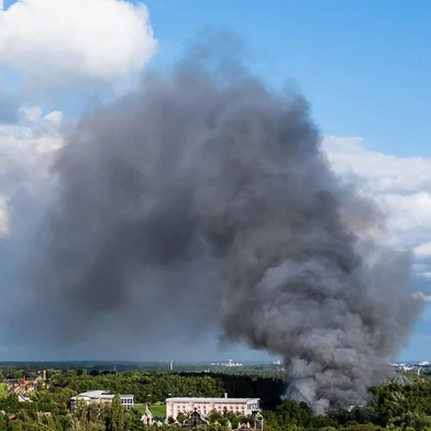 Smoke caused by a fire billows above the site of the Tomorrowland electronic music festival in Boom, northern Belgium on July 16, 2025. (Photo by Tom Goyvaerts / Belga / AFP) / Belgium OUT<!-- NICAID(16082198) -->