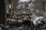 (FILES) In this file photo taken on March 4, 2022 Destroyed Russian armored vehicles line the street in the city of Bucha, west of Kyiv. - Russian forces pulled back from the commuter town northwest of the capital on March 31, 2022, just over one month after President Vladimir Putin ordered his troops to invade Ukraine. A year after its liberation by Ukrainian forces, Bucha and its people are still confronted by the atrocities blamed on Russian forces during their occupation of the city. President Volodymyr Zelensky said Friday that Ukraine would "never forgive" Moscow for its occupation of Bucha, one year after Russia withdrew from the town near Kyiv leaving corpses strewn throughout deserted streets. (Photo by ARIS MESSINIS / AFP)<!-- NICAID(15390662) -->