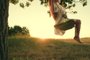 Child plays on wooden swing, dreams of flying. Happy little girl swings on swing in park under tree at sunset. Baby swing, kid girl smile in flight. Concept of family happiness, dreams, entertainmentPessoa em um balanço - Foto: zoteva87/stock.adobe.comFonte: 659211717<!-- NICAID(15600669) -->