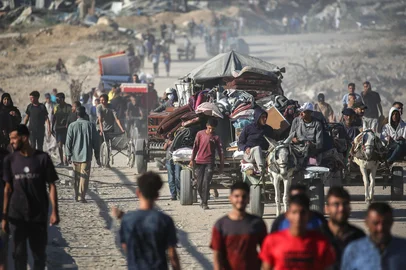 Palestinians make their way to Gaza City through the so-called "Netzarim corridor" from Nuseirat in the central Gaza Strip on October 11, 2025. Israel declared a ceasefire in Gaza and began to pull back its forces on October 10, as tens of thousands of exhausted Palestinians made their way back to their devastated homes. (Photo by Eyad BABA / AFP)<!-- NICAID(16144093) -->