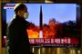 A man walks past a television report showing a news broadcast with file footage of a North Korean missile test, at a railway station in Seoul on January 14, 2022, after North Korea fired an unidentified projectile eastward in the country's third suspected weapons test in just over a week. (Photo by Anthony WALLACE / AFP)<!-- NICAID(14989809) -->
