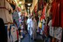People walk in Souq Waqif marketplace in Doha on November 30, 2022, during the Qatar 2022 World Cup football tournament. (Photo by OZAN KOSE / AFP)<!-- NICAID(15287051) -->