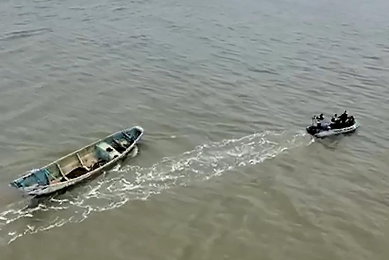 Grab from a handout video released on April 14, 2024 by the Brazilian Federal Police showing police members dragging the boat where twenty suspected Haitian migrants have been found dead on April 13, 2024 in the state of Para, Brazil. Fishermen alerted the authorities after finding the boat near the town of Braganca with the bodies in an advanced state of decomposition and showing signs of dehydration and hunger, police said. (Photo by Handout / BRAZILIAN FEDERAL POLICE / AFP) / RESTRICTED TO EDITORIAL USE - MANDATORY CREDIT "AFP PHOTO / BRAZILIAN FEDERAL POLICE" - NO MARKETING - NO ADVERTISING CAMPAIGNS - DISTRIBUTED AS A SERVICE TO CLIENTS<!-- NICAID(15735965) -->