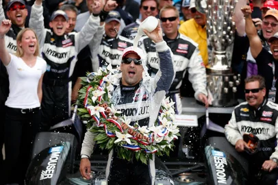 Tony Kanaan of Brazil, driver of the Hydroxycut KV Racing Technology-SH Racing Chevrolet, pours the victory milk over his head as he celebrates in victory circle after winning the IZOD IndyCar Series 97th running of the Indianapolis 500 mile race at the Indianapolis Motor Speedway on May 26, 2013 in Indianapolis, Indiana.   Chris Graythen/Getty Images/AFP