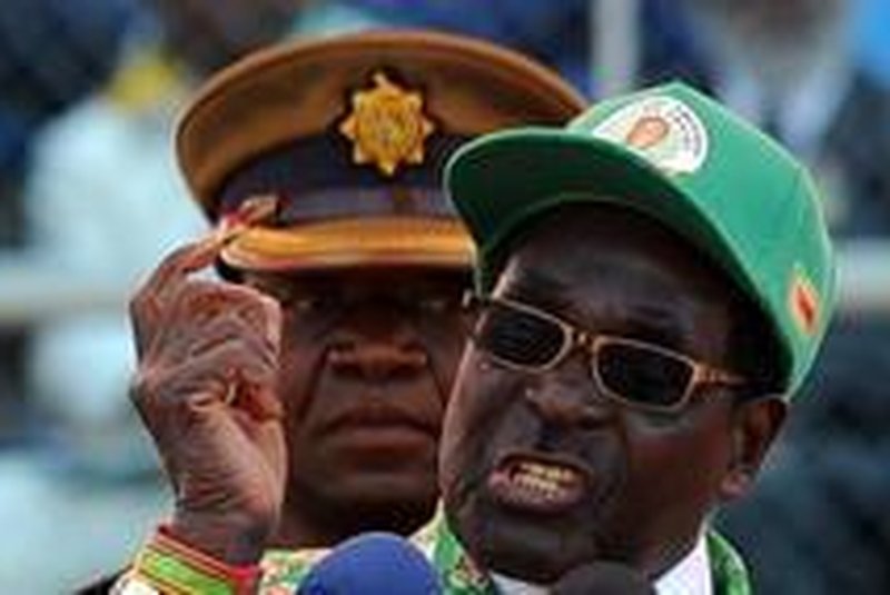 Zimbabwe's President Robert Mugabe addresses at a rally in Harare on July 28, 2013. Zimbabweans go to the polls on July 31 to choose between veteran President Robert Mugabe and long-time rival Morgan Tsvangirai. AFP PHOTO / ALEXANDER JOE
