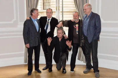 British comedy troupe Monty Python, (L-R) Michael Palin, Eric Idle, Terry Jones, Terry Gilliam and John Cleese pose for a photograph during a media event in central London on November 21, 2013. Cue endless jokes about resting parrots -- the five surviving members of Monty Python, Britain's cult comedy troupe, announced on November 21 they will take to the stage again next year, three decades after their last performance together. AFP PHOTO / LEON NEAL