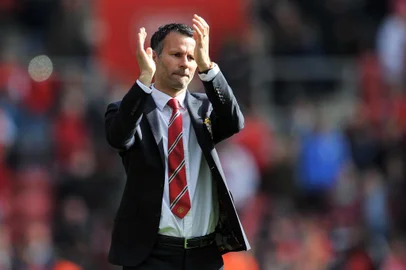 Manchester United Interim manager Ryan Giggs thanks the fans after the English Premier League football match between Southampton and Manchester United at St Mary's stadium in in Southampton on May 11, 2014.  The match ended in a 1-1 draw. AFP PHOTO/GLYN KIRK - RESTRICTED TO EDITORIAL USE. No use with unauthorized audio, video, data, fixture lists, club/league logos or live services. Online in-match use limited to 45 images, no video emulation. No use in betting, games or single club/league/player publications.