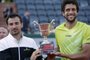 534885921Brazil's Marcelo Melo (R) and Croatia's Ivan Dodig celebrate with the trophy following their victory over US Bob and Mike Bryan celebrate at the end of the men's double final match of the Roland Garros 2015 French Tennis Open in Paris on June 6, 2015.    AFP PHOTO / KENZO TRIBOUILLARDEditoria: SPOLocal: ParisIndexador: KENZO TRIBOUILLARDSecao: TennisFonte: AFPFotógrafo: STF