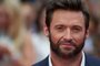 Australian actor Hugh Jackman poses for pictures on the red carpet as he arrives for the UK premier of the film 'The Wolverine' in London on July 16, 2013.