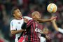 Walter from Brazil's Atletico Paranaense vies for the ball with Arnaldo (L) from Brazil's Joinvilleduring their Sudamericana Cup football match at the Arena da Baixada stadium in Curitiba on August 27, 2015.   AFP PHOTO / HEULER ANDREY