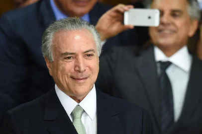 Brazilian acting President Michel Temer gestures during the inauguration ceremony of the new ministers at Planalto Palace, in Brasilia, on May 12, 2016.