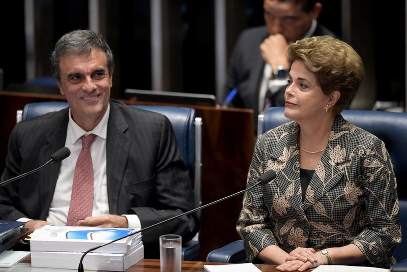 Suspended Brazilian President Dilma Rousseff gestures next to her attorney in the impeachment proceedings, Jose Eduardo Cardozo (L) before delivering her speech during the impeachment trial, at the National Congress in Brasilia, on August 29, 2016.Rousseff arrived at the Senate to defend herself confronting her accusers in a dramatic finale to a Senate impeachment trial likely to end 13 years of leftist rule in Latin Americas biggest country. / AFP PHOTO / EVARISTO SA