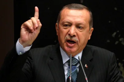 Turkeys Prime Minister Recep Tayyip Erdogan gestures as he gives a speech during a meeting at his ruling Justice and Development Party (AKP) party headquarters in Ankara, on August 20, 2013. Turkish Prime Minister Recep Tayyip Erdogan accused Israel on August 20 of being behind the military-backed ouster of Egypts Islamist president Mohamed Morsi last month.  AFP PHOTO / ADEM ALTAN