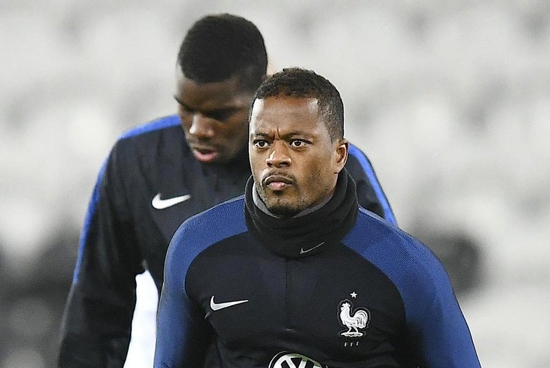 (FILES) This file photo taken on November 14, 2016 shows Frances defender Patrice Evra running during a training session at the Bollaert stadium in Lens on November 14, 2016, on the eve of the friendly football match against Ivory Coast. French international defender of Juventus Turin Patrice Evra, 35, will commit for 18 months to Marseille, announced January 23, according to various French media.FRANCK FIFE / AFP
