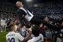 Real Madrids French head coach Zinedine Zidane is tossed by players at the end of the Spanish league football match Malaga CF vs Real Madrid at La Rosaleda stadium in Malaga on May 21, 2017.Real Madrid won their 33rd La Liga title and first for five years as Cristiano Ronaldos 40th goal of the season helped seal a 2-0 win at Malaga today. / AFP PHOTO / SERGIO CAMACHO