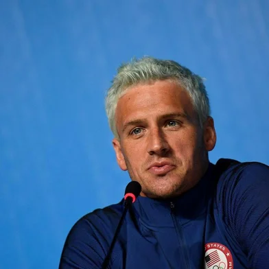(FILES) This file photo taken on August 03, 2016 shows US swimmer Ryan Lochte holding a press conference in Rio de Janeiro, two days ahead of the opening ceremony of the Rio 2016 Olympic Games.Brazilian police have prevented two more U.S. swimmers from leaving the country after the Rio de Janeiro Olympics over the investigation of a robbery complaint by teammate Ryan Lochte. According to a report on O Globo Web site, swimmers Gunnar Bentz and Jack Conger were arrested and removed from their plane so Brazilian federal police could interview them Wednesday night. The U.S. Olympic Committee later confirmed their detention. / AFP PHOTO / MARTIN BUREAU