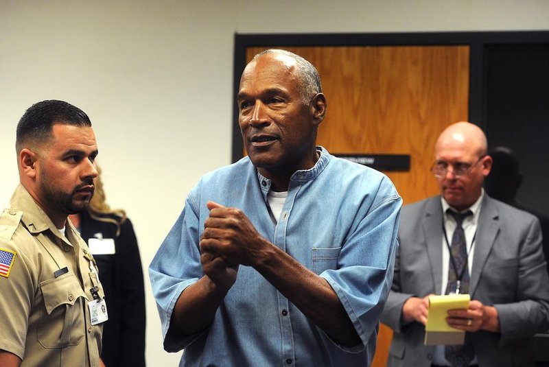 O.J. Simpson (C) reacts after learning he was granted parole during his parole hearing at the Lovelock Correctional Center in Lovelock, Nevada on July 20, 2017.Disgraced former American football star O.J. Simpson was granted his release from prison on Thursday after serving nearly nine years behind bars for armed robbery.A four-member parole board in the western US state of Nevada voted unanimously to free the 70-year-old Simpson after a public hearing broadcast live by US television networks. / AFP PHOTO / POOL / Jason Bean / RESTRICTED TO EDITORIAL USE - MANDATORY CREDIT AFP PHOTO /POOL/Reno Gazette-Journal/ Jason Bean - NO MARKETING NO ADVERTISING CAMPAIGNS - DISTRIBUTED AS A SERVICE TO CLIENTS