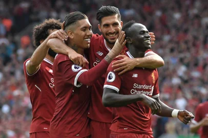Liverpools Senegalese midfielder Sadio Mane (R) celebrates with teammates after scoring their second goal during the English Premier League football match between Liverpool and Arsenal at Anfield in Liverpool, north west England on August 27, 2017. / AFP PHOTO / Anthony Devlin / RESTRICTED TO EDITORIAL USE. No use with unauthorized audio, video, data, fixture lists, club/league logos or live services. Online in-match use limited to 75 images, no video emulation. No use in betting, games or single club/league/player publications.  / 