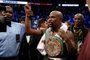 Floyd Mayweather Jr. v Conor McGregorLAS VEGAS, NV - AUGUST 26: Floyd Mayweather Jr. celebrates with the WBC Money Belt after his TKO of Conor McGregor in their super welterweight boxing match on August 26, 2017 at T-Mobile Arena in Las Vegas, Nevada.   Christian Petersen/Getty Images/AFPEditoria: SPOLocal: Las VegasIndexador: Christian PetersenSecao: BoxingFonte: GETTY IMAGES NORTH AMERICAFotógrafo: STF