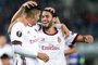 AC Milans forward from Portugal Andre Silva (L) celebrates scoring with midfielder from Turkey Hakan Calhanoglu during the UEFA Europa League group D football match FK Austria Wien v AC Milan in Vienna, Austria on September 14, 2017.  / AFP PHOTO / APA / GEORG HOCHMUTH / Austria OUT