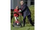 US President Donald Trump pats Frank Giaccio, 11, of Falls Church, Virginia, on the back as he mows the lawn in the Rose Garden of the White House on September 15, 2017, in Washington, DC.                 
Giaccio, who has his own lawn mowing business wrote a letter to the President asking if he could mow the lawn at the White House.  / AFP PHOTO / Mike Theiler
