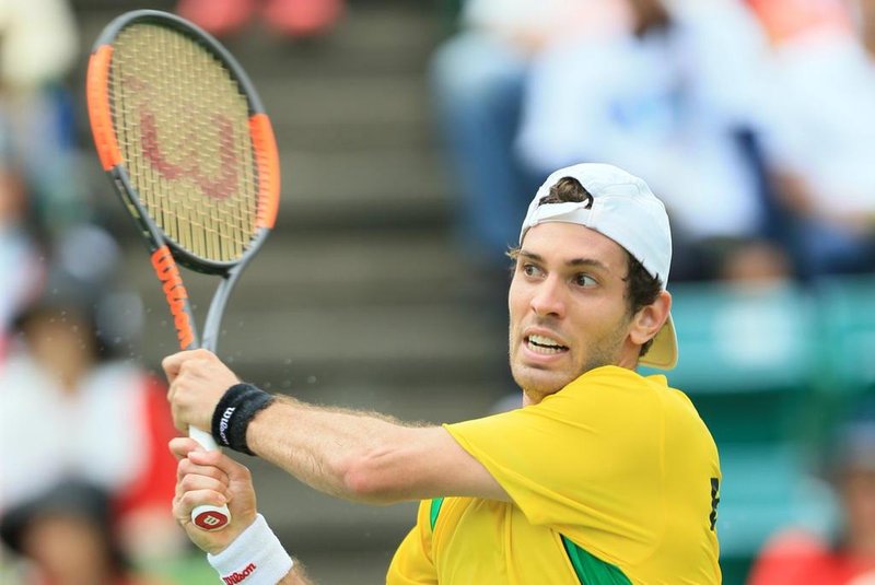 Guilherme Clezar of Brazil hits a return to Yuichi Sugita of Japan during the first tennis match of the Davis Cup World Group playoff between Japan and Brazil in Osaka on September 15, 2017.  / AFP PHOTO / JIJI PRESS / STR / Japan OUT