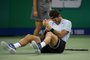 Juan Martin Del Potro of Argentina grimaces and holds his left hand after he fell during his mens singles quarter-final match against Viktor Troicki of Serbia at the Shanghai Masters tennis tournament in Shanghai on October 13, 2017. / AFP PHOTO / NICOLAS ASFOURI