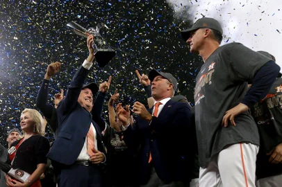 HOUSTON, TX - OCTOBER 21: The Houston Astros celebrate with the The William Harridge Trophy after defeating the New York Yankees by a score of 4-0 to win Game Seven of the American League Championship Series at Minute Maid Park on October 21, 2017 in Houston, Texas. The Houston Astros advance to face the Los Angeles Dodgers in the World Series.   Elsa/Getty Images/AFP