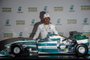 F1 World Champion, Mercedes British driver Lewis Hamilton, poses behind a replica of a Mercedes racing car customized with an image of late Brazilian F1 driver Ayrton Senna, after a press conference in Sao Paulo, Brazil, on November 8, 2017 ahead of Sundays Formula One Brazilian Grand Prix. / AFP PHOTO / Nelson ALMEIDA
