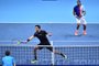 Brazils Marcelo Melo (L) and Polands Lukasz Kubot return against Finlands Henri Kontinen and Australias John Peers during their mens doubles final match on day eight of the ATP World Tour Finals tennis tournament at the O2 Arena in London on November 19, 2017. / AFP PHOTO / Glyn KIRK