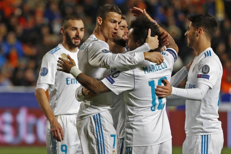Real Madrids Portuguese forward Cristiano Ronaldo (2nd-R) celebrates with teammates his first goal, and his teams fifth, during the UEFA Champions League Group H match between Apoel FC and Real Madrid on November 21, 2017, in the Cypriot capital Nicosias GSP Stadium.  / AFP PHOTO / Jack GUEZ