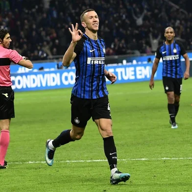 Inter Milans Croatian forward Ivan Perisic celebrates after scoring during the Italian Serie A football match Inter Milan vs Chievo on December 3, 2017 at the San Siro stadium in Milan.  / AFP PHOTO / MIGUEL MEDINA