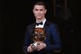 This handout photo released on December 7, 2017 by LEquipe shows Portugese player Cristiano Ronaldo posing with the 2017 Ballon dOr France Football trophy in Paris.
Portuguese star Cristiano Ronaldo won a record-equalling fifth Ballon dOr (2008, 2013, 2015, 2016 and 2017) award for the years best player on December 7. The Real Madrid forwards second successive win draws him level alongside Barcelona rival Lionel Messi on five Ballon dOrs, after beating the Argentinian and Brazilian Neymar. / AFP PHOTO / LEQUIPE / Franck FAUGERE / RESTRICTED TO EDITORIAL USE - MANDATORY CREDIT AFP PHOTO / LEQUIPE / FRANCK FAUGERE - NO MARKETING NO ADVERTISING CAMPAIGNS - DISTRIBUTED AS A SERVICE TO CLIENTS

