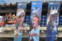 Workmen put the final touches to banners covering construction work at a building in Melbourne Park ahead of the Australian Open tennis tournament in Melbourne on January 12, 2018. / AFP PHOTO / PAUL CROCK / IMAGE RESTRICTED TO EDITORIAL USE - STRICTLY NO COMMERCIAL USE