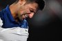 Serbias Novak Djokovic reacts during their mens singles fourth round match against South Koreas Hyeon Chung on day eight of the Australian Open tennis tournament in Melbourne on January 22, 2018. / AFP PHOTO / Paul Crock / -- IMAGE RESTRICTED TO EDITORIAL USE - STRICTLY NO COMMERCIAL USE --