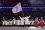 Unified Koreas flagbearers (North Koreas ice hockey player) Hwang Chung Gum (L) and (South Koreas bobsledder) Won Yun-jong (R) lead the Unified Koreas delegation as they parade during the opening ceremony of the Pyeongchang 2018 Winter Olympic Games at the Pyeongchang Stadium on February 9, 2018.  / AFP PHOTO / Mark RALSTON