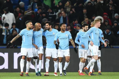 Manchester Citys German midfielder Ilkay Gundogan (3rd L) celebrates with teammates after scoring his second goal during the UEFA Champions League round of 16 first leg football match between Basel and Manchester City at the Saint Jakob-Park Stadium in Basel on February 13, 2018. / AFP PHOTO / SEBASTIEN BOZON