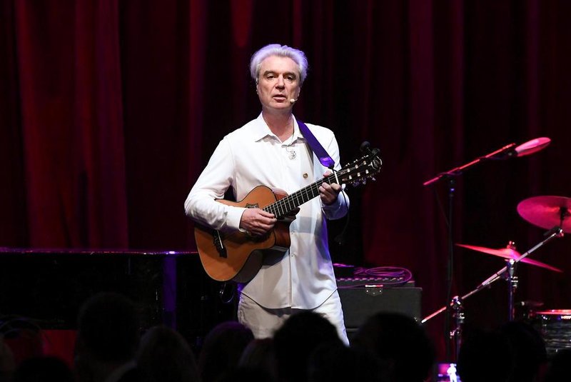 (FILES) In this file photo taken on May 11, 2017 David Byrne performs onstage during the WITNESS 25th Anniversary Gala at The Edison Ballroom in New York City.   David Byrne, an underground icon since the 1970s, has earned his first Top 10 album in the United States with his latest work, American Utopia. The album debuted at number three on the Billboard chart, selling 63,000 copies in the week through March 15, 2018, tracking service Nielsen Music said.Nielsen attributed the success in part to a bundling arrangement that sees fans buy the album as part of a package with tickets to Byrnes tour. / AFP PHOTO / GETTY IMAGES NORTH AMERICA / Dia Dipasupil