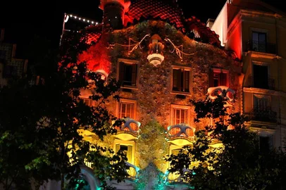 Picture shows the The Casa Batllo, designed by Spanish architect Antoni Gaudi, illuminated with the rainbow colours in Barcelona, on June 28, 2017. / AFP PHOTO / LLUIS GENE