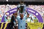 Manchester Citys Brazilian striker Gabriel Jesus holds the Premier League trophy on the pitch after the English Premier League football match between Manchester City and Huddersfield Town at the Etihad Stadium in Manchester, north west England, on May 6, 2018. / AFP PHOTO / Oli SCARFF / RESTRICTED TO EDITORIAL USE. No use with unauthorized audio, video, data, fixture lists, club/league logos or live services. Online in-match use limited to 75 images, no video emulation. No use in betting, games or single club/league/player publications.  / 