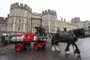 In this file photo taken on March 28, 2018 Derek and Paul drive a horse carriage delivering the new Harry & Meghans Windsor Knot ale, a limited edition craft beer brewed to mark the royal wedding of Prince Harry and Meghan Markle, past Windsor Castle in Windsor, England. The highly-anticipated marriage between Britains Prince Harry and US actress Meghan Markle in Windsor on May 19 has generated a slew of quirky side-stories and offbeat tributes.