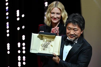 Japanese director Hirokazu Kore-Eda (R) poses on stage with Australian actress and President of the Jury Cate Blanchett after he was awarded with the Palme dOr for the film Shoplifters (Manbiki Kazoku) on May 19, 2018 during the closing ceremony of the 71st edition of the Cannes Film Festival in Cannes, southern France.  / AFP PHOTO / Alberto PIZZOLI