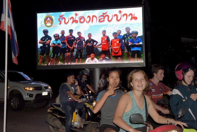 Motorists pass a billboard with a photograph showing members of the Thai children's football team "Wild Boar" and their coach with a message "welcome home brothers" displayed in Chiang Rai as the boys and their coach were all rescued in the Tham Luang cave in Khun Nam Nang Non Forest Park in the Mae Sai district on July 10, 2018.All 12 boys and their coach who became trapped in a flooded Thai cave more than a fortnight ago have been rescued, the Navy SEALs announced on July 10, completing an astonishing against-the-odds rescue mission that has captivated the world. / AFP PHOTO / TANG CHHIN Sothy