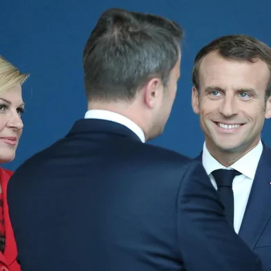 France's President Emmanuel Macron (2nd R), US President Donald Trump (R) and Croatia President Kolinda Grabar-Kitarovic arrive for the NATO (North Atlantic Treaty Organization) summit, at the NATO headquarters in Brussels, on July 11, 2018.  / AFP PHOTO / POOL / Tatyana ZENKOVICH